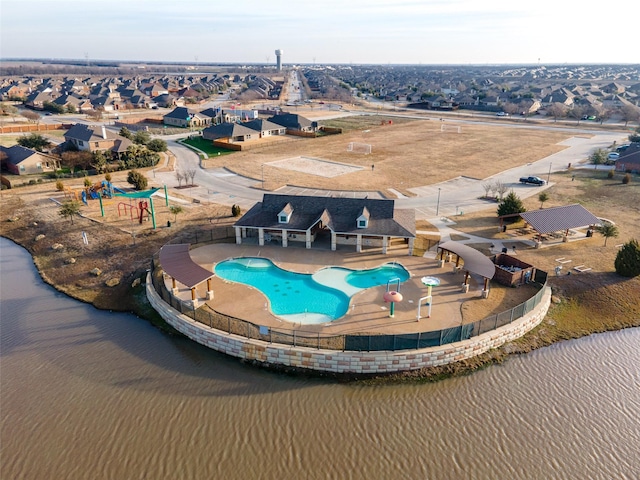 view of swimming pool featuring a water view and a patio area