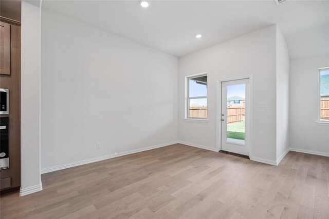 unfurnished bedroom featuring a closet, light carpet, and lofted ceiling