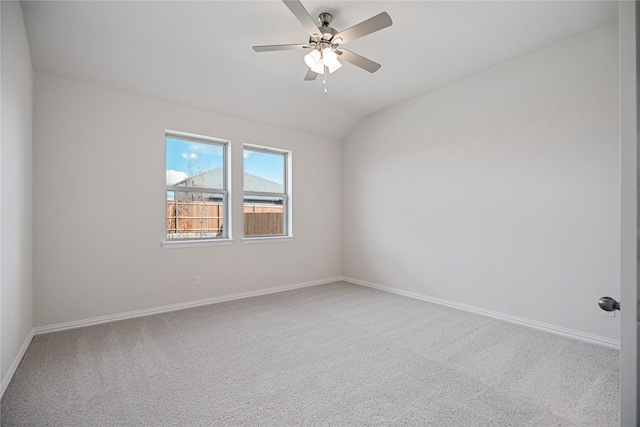 empty room featuring ceiling fan, lofted ceiling, and carpet floors