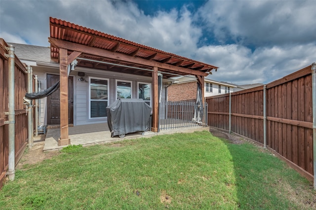 rear view of property with a yard and a patio area