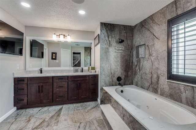 bathroom with vanity, shower with separate bathtub, and a textured ceiling