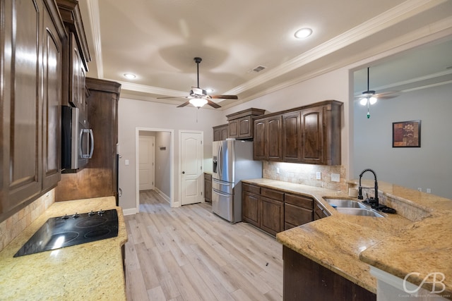 kitchen featuring kitchen peninsula, ceiling fan, and stainless steel appliances