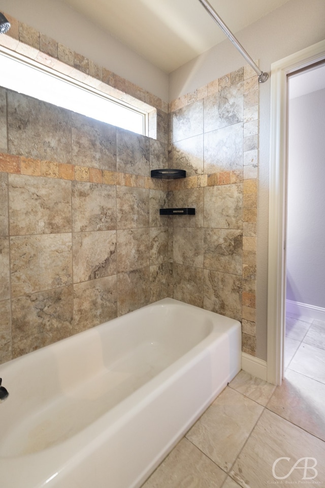 bathroom with tiled shower / bath and tile patterned floors