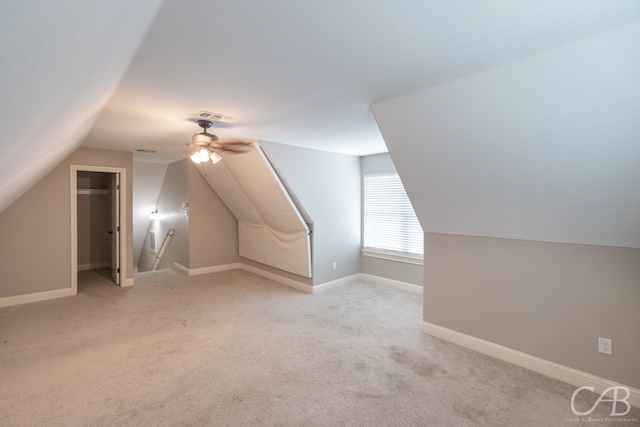 additional living space with vaulted ceiling, ceiling fan, and light colored carpet