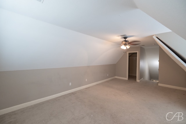 additional living space with lofted ceiling, ceiling fan, and carpet flooring