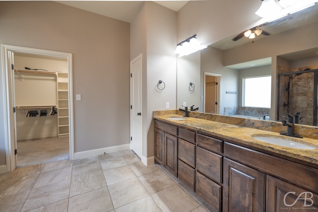 bathroom featuring tile patterned floors, a shower with shower door, and vanity