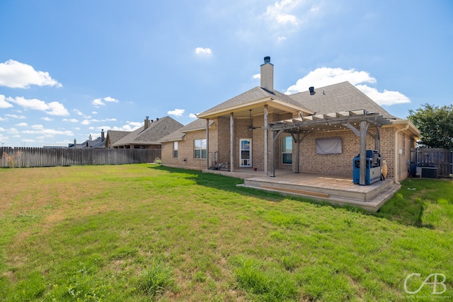 rear view of house with a lawn, a pergola, central air condition unit, and a patio area