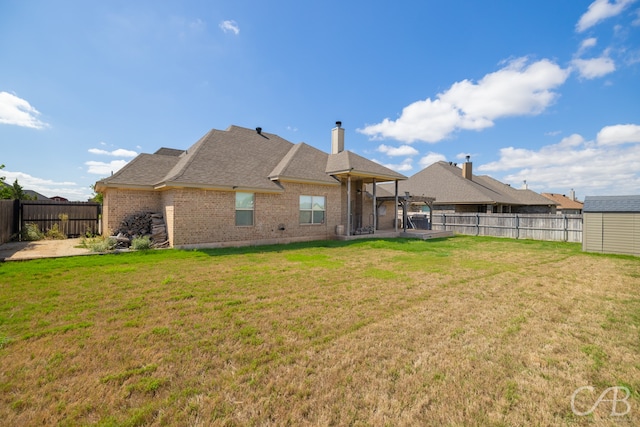 rear view of house featuring a lawn and a patio area