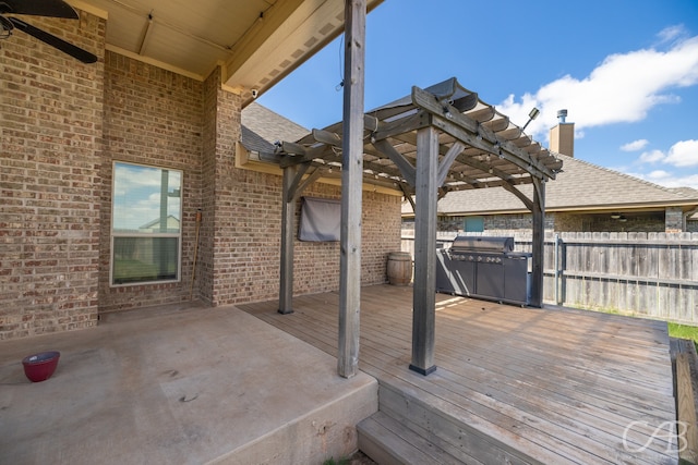 deck with a pergola and a grill