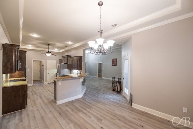 kitchen featuring appliances with stainless steel finishes, ceiling fan with notable chandelier, crown molding, and light hardwood / wood-style flooring