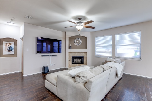 living room featuring ceiling fan, dark hardwood / wood-style flooring, and a high end fireplace