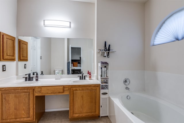 bathroom featuring a bathing tub, vanity, and tile patterned floors