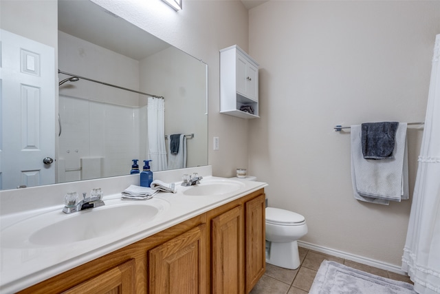 bathroom featuring vanity, tile patterned flooring, toilet, and curtained shower