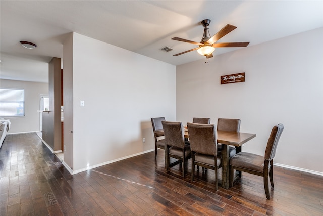 dining space with ceiling fan and dark wood-type flooring