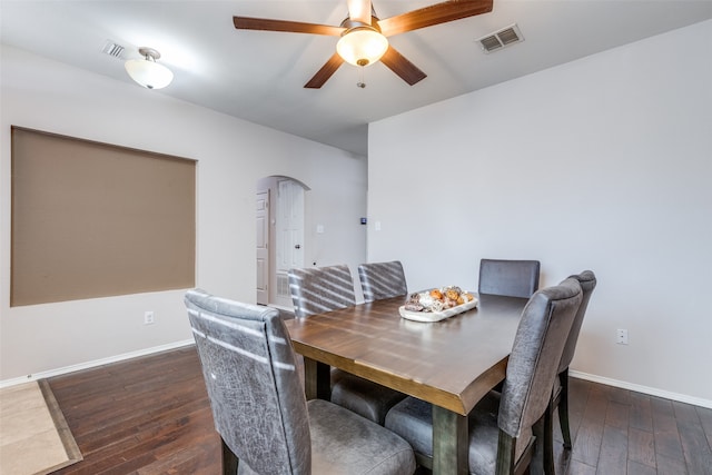 dining area with ceiling fan and dark hardwood / wood-style flooring