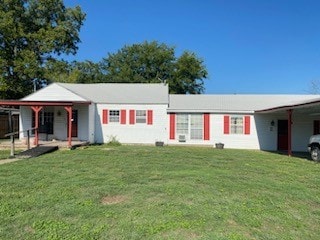 ranch-style home with a front lawn