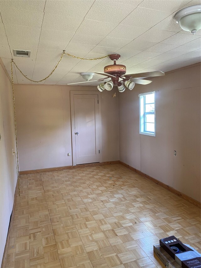 spare room featuring ceiling fan, a textured ceiling, and light parquet floors