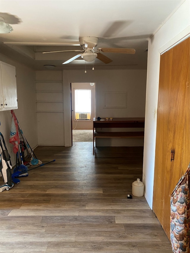 interior space with ceiling fan, cooling unit, a closet, and wood-type flooring