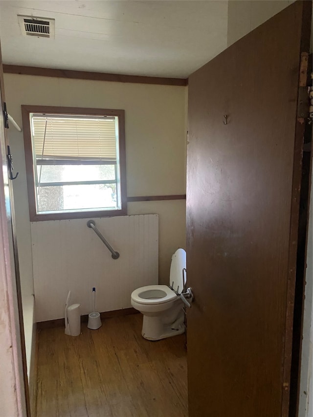 bathroom featuring hardwood / wood-style floors and toilet