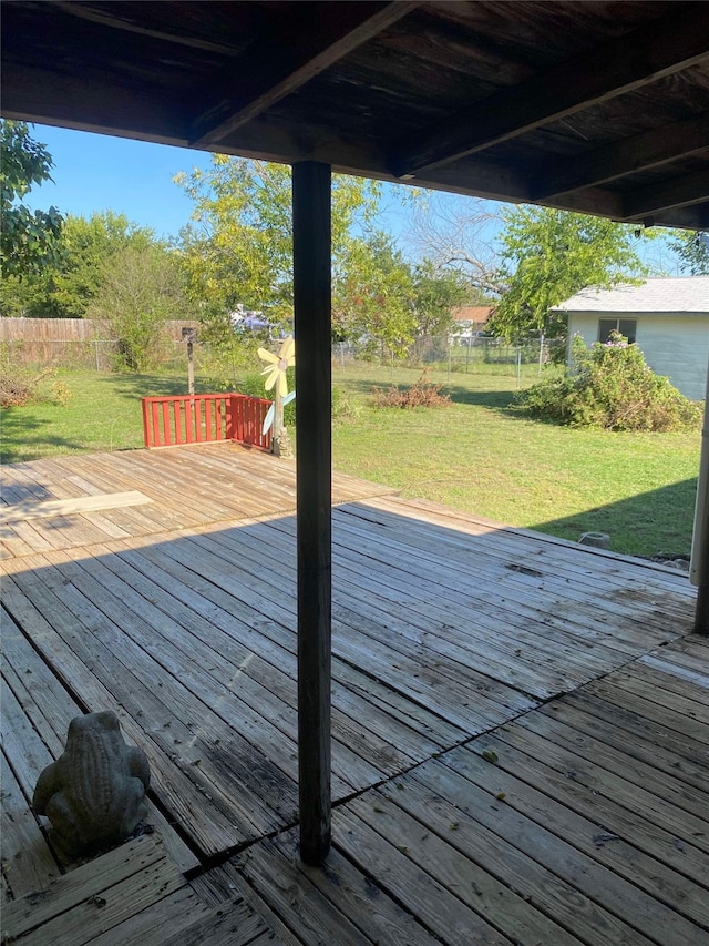 wooden terrace featuring a lawn