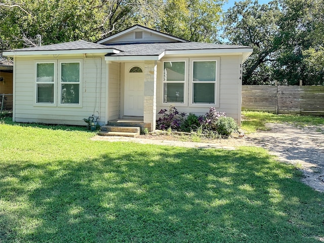 bungalow-style home featuring a front lawn