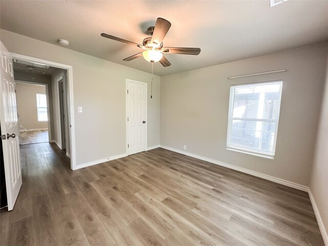 unfurnished bedroom featuring wood-type flooring and ceiling fan