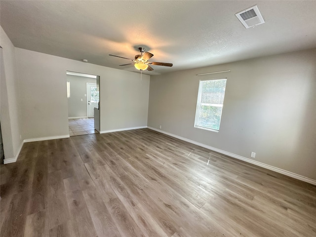 unfurnished room featuring a textured ceiling, ceiling fan, and hardwood / wood-style flooring