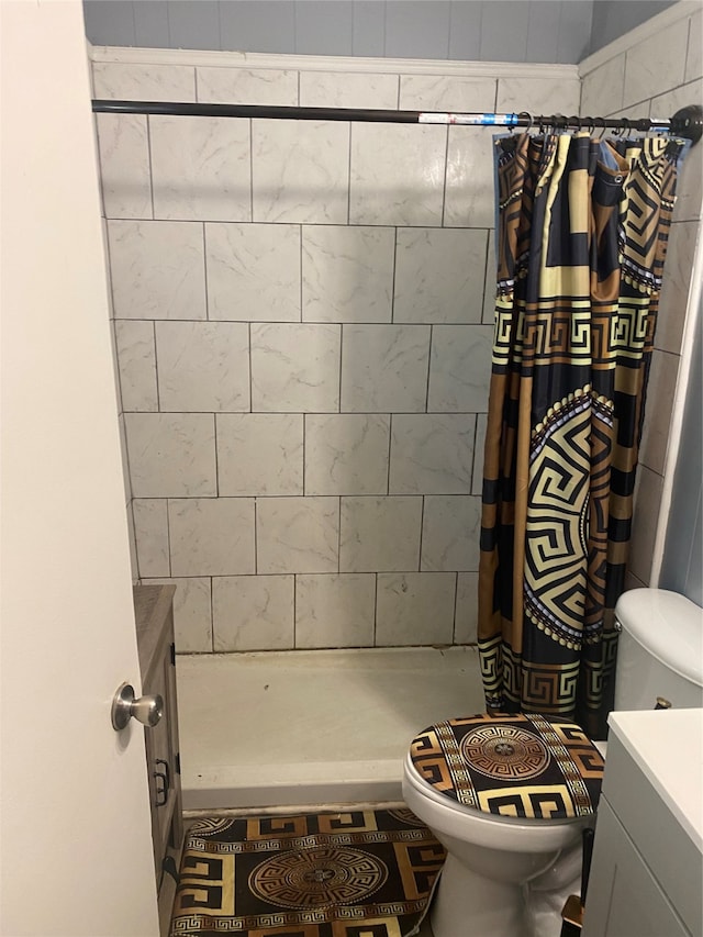 bathroom with a shower with shower curtain, vanity, and toilet