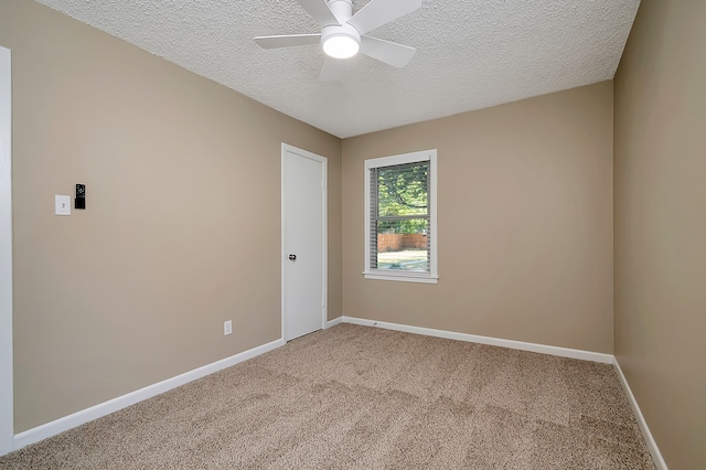 carpeted empty room with a textured ceiling and ceiling fan