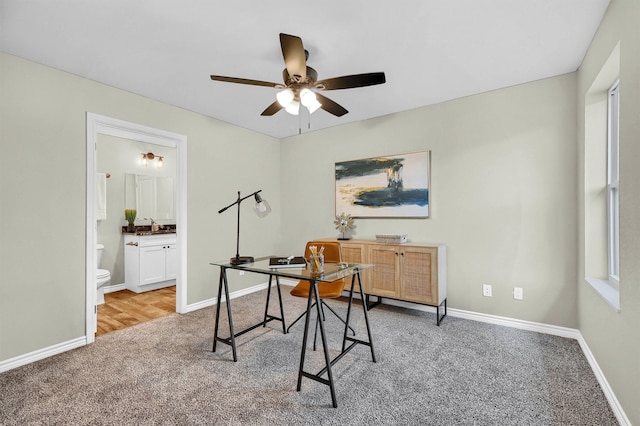 office space with light carpet and ceiling fan