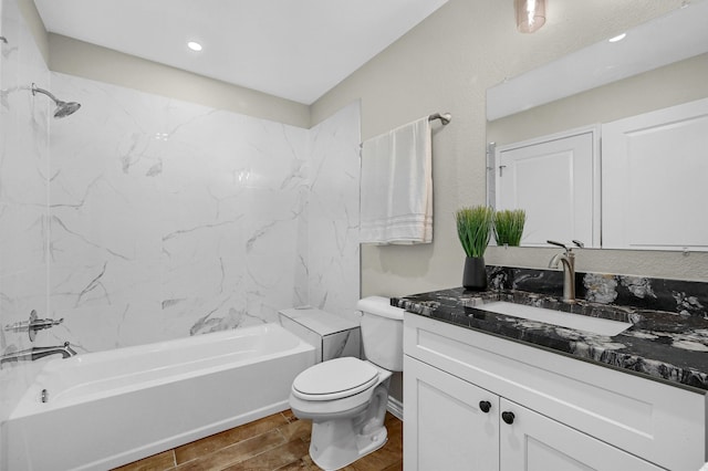 full bathroom with toilet, tiled shower / bath combo, vanity, and hardwood / wood-style flooring