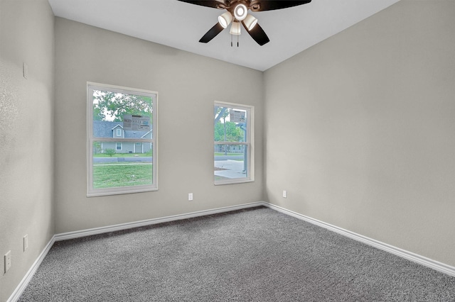 unfurnished room with a wealth of natural light, carpet, and ceiling fan