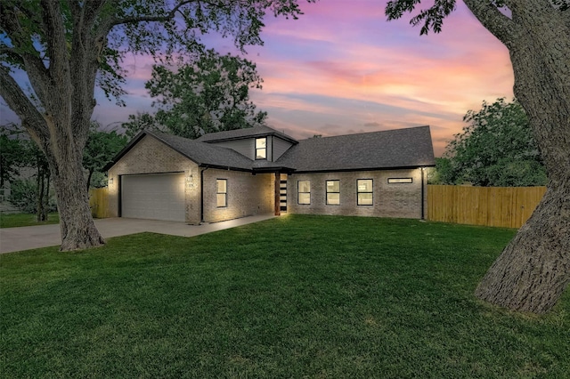 view of front of home with a lawn and a garage