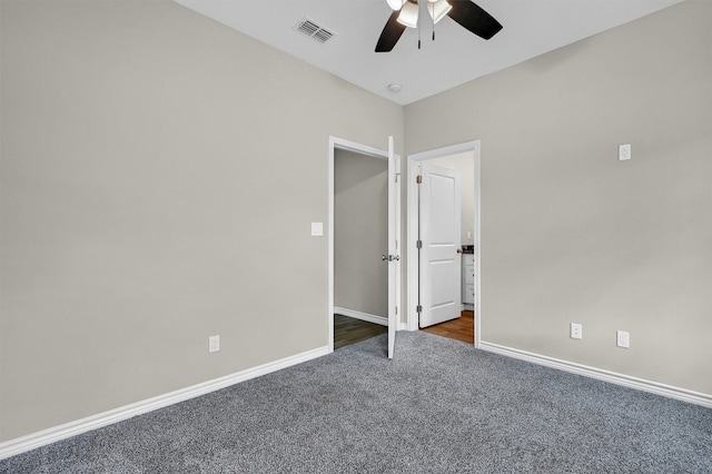 unfurnished bedroom featuring dark colored carpet and ceiling fan