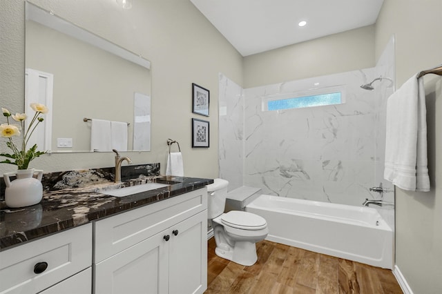 full bathroom featuring toilet, vanity, tiled shower / bath, and wood-type flooring