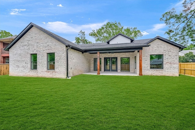 back of house with a lawn and a patio area