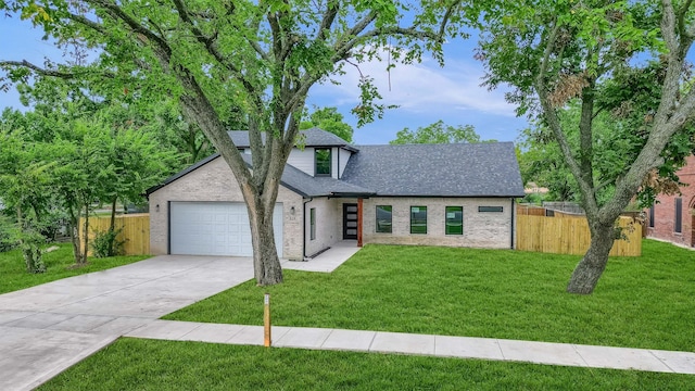 view of front of property featuring a garage and a front yard