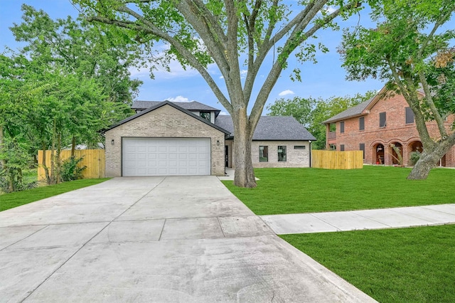 view of front of property featuring a front lawn and a garage