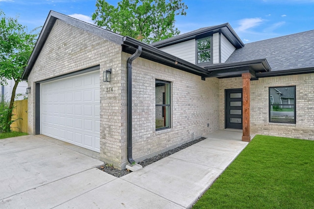 view of front of home with a garage and a front yard