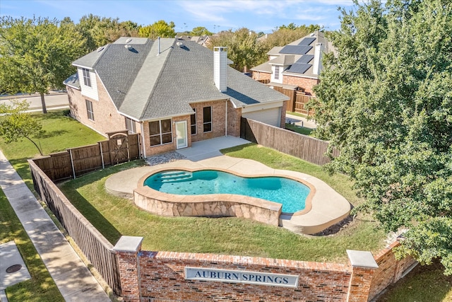 view of swimming pool featuring a patio area and a yard