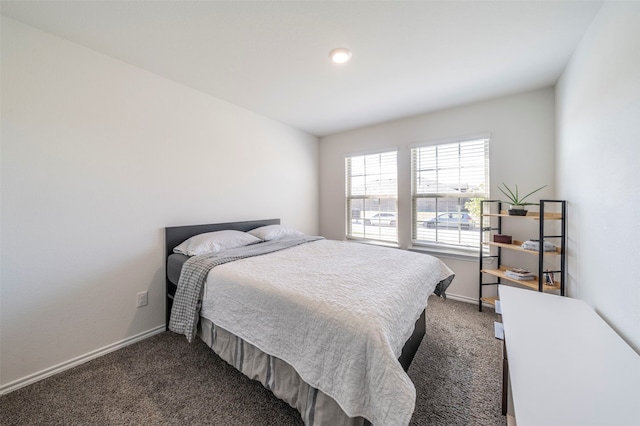 bedroom featuring dark carpet