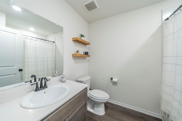 bathroom with vanity, hardwood / wood-style floors, and toilet