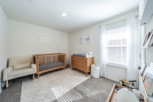 carpeted bedroom with a crib