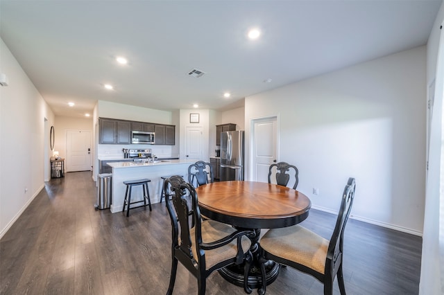 dining space featuring dark hardwood / wood-style flooring