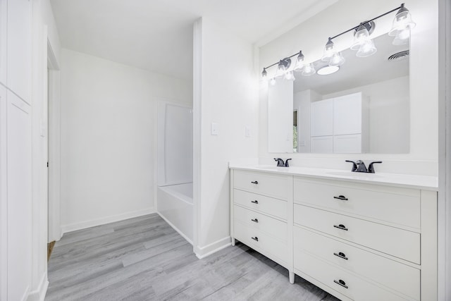 bathroom with wood-type flooring, vanity, and separate shower and tub