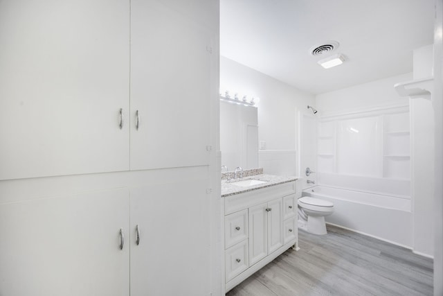 full bathroom with hardwood / wood-style flooring, vanity, toilet, and shower / bath combination