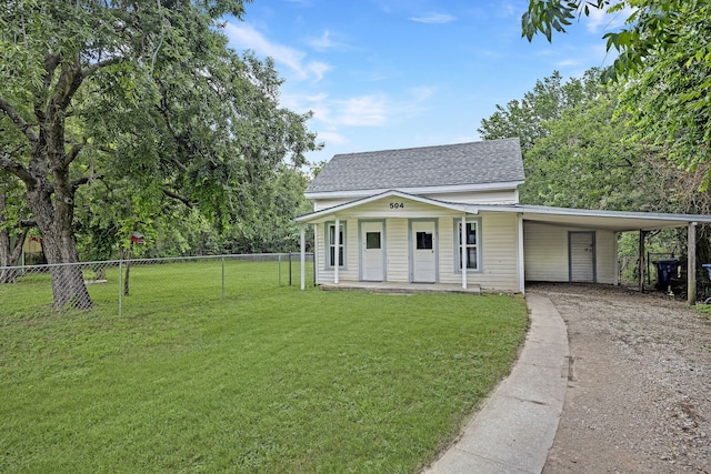 view of front of house with a front yard and a carport