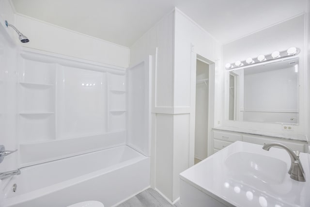 bathroom with shower / bathing tub combination, wood-type flooring, and vanity