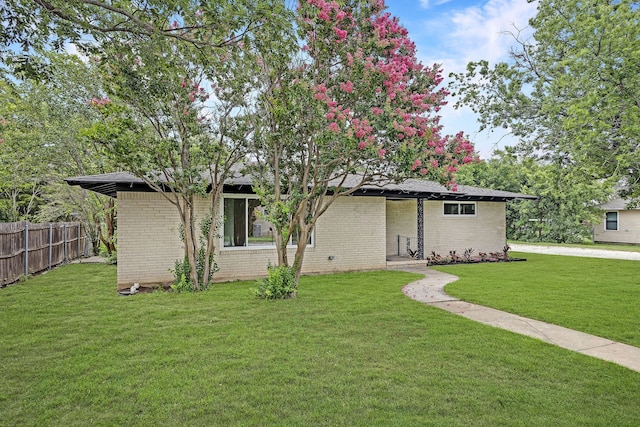 ranch-style home with a front lawn