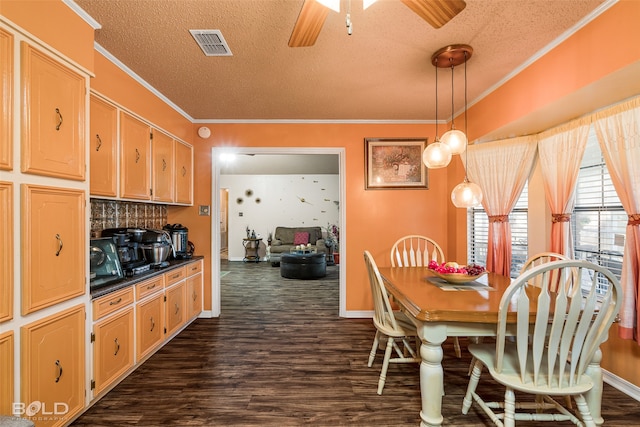 dining area with a textured ceiling, crown molding, and dark wood-type flooring